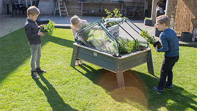 Playing outside in a small garden with EXIT Toys